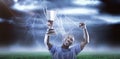 Composite image 3D of happy sportsman looking up and cheering while holding trophy Royalty Free Stock Photo