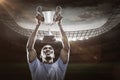 Composite image 3D of happy sportsman looking up while holding trophy Royalty Free Stock Photo
