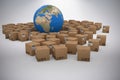 Composite image of 3d image of globe amidst cardboard boxes Royalty Free Stock Photo