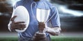 Composite image 3D of mid section of sportsman holding trophy and rugby ball