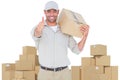 Composite image of delivery man with cardboard box gesturing thumbs up Royalty Free Stock Photo