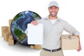 Composite image of delivery man with cardboard box showing clipboard Royalty Free Stock Photo