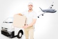 Composite image of delivery man carrying cardboard box Royalty Free Stock Photo