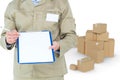 Composite image of delivery man showing blank paper on clipboard Royalty Free Stock Photo