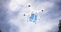 Composite image of digital composite image of quadcopter with blue and white striped gift box