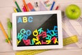 Composite image of digital tablet on students desk Royalty Free Stock Photo