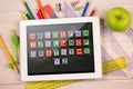 Composite image of digital tablet on students desk Royalty Free Stock Photo