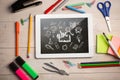 Composite image of digital tablet on students desk Royalty Free Stock Photo