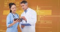 Composite image of doctor and nurse looking at clipboard Royalty Free Stock Photo