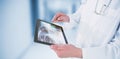 Composite image of doctor using digital tablet Royalty Free Stock Photo