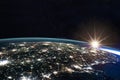 Composite image of the earth view from space with the lights of the cities illuminated at night. Human activities, g Royalty Free Stock Photo