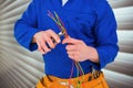 Composite image of electrician cutting wire with pliers Royalty Free Stock Photo