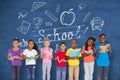 Composite image of elementary pupils reading books Royalty Free Stock Photo