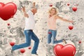 Composite image of excited couple cheering and jumping