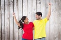 Composite image of excited couple cheering in red and yellow tshirts