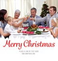 Composite image of family drinking a toast in a christmas dinner Royalty Free Stock Photo