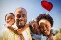 Composite image of family and red heart balloon 3d Royalty Free Stock Photo