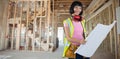 Composite image of female architect holding blueprint against white background Royalty Free Stock Photo