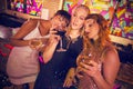 Composite image of female friends having glass of champagne and wine