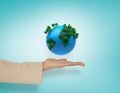 Composite image of female hand presenting blue earth Royalty Free Stock Photo