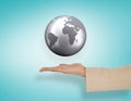 Composite image of female hand presenting globe Royalty Free Stock Photo
