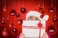 Composite image of festive blonde holding christmas gift Royalty Free Stock Photo