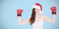 Composite image of festive brunette in boxing gloves with arms raised Royalty Free Stock Photo