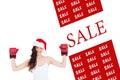 Composite image of festive brunette in boxing gloves with arms raised Royalty Free Stock Photo