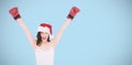 Composite image of festive brunette in boxing gloves cheering Royalty Free Stock Photo