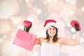 Composite image of festive brunette in boxing gloves holding shopping bags Royalty Free Stock Photo