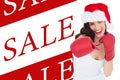 Composite image of festive brunette in boxing gloves punching Royalty Free Stock Photo