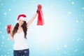 Composite image of festive brunette in boxing gloves with shopping bag Royalty Free Stock Photo