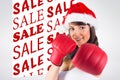 Composite image of festive brunette punching with boxing gloves Royalty Free Stock Photo