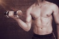 Composite image of fit shirtless man lifting dumbbell Royalty Free Stock Photo