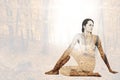 Composite image of fit woman doing the half spinal twist pose in fitness studio Royalty Free Stock Photo