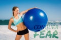 A Composite image of fit woman standing on the beach holding exercise ball