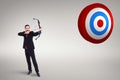 Composite image of focused businessman shooting a bow and arrow Royalty Free Stock Photo