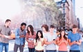 Composite image of four people standing beside each other and texting on their phones Royalty Free Stock Photo