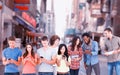 Composite image of four people standing beside each other and texting on their phones Royalty Free Stock Photo