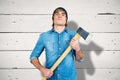 Composite image of front view of hipster standing with axe