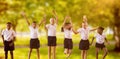 Composite image of full length of students in school uniforms jumping Royalty Free Stock Photo