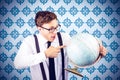 Composite image of geeky businessman pointing to globe Royalty Free Stock Photo