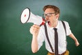 Composite image of geeky businessman shouting through megaphone Royalty Free Stock Photo