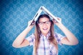 Composite image of geeky hipster holding her laptop over her head Royalty Free Stock Photo