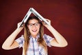 Composite image of geeky hipster holding her laptop over her head Royalty Free Stock Photo