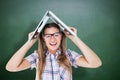 Composite image of geeky hipster holding her laptop over her head Royalty Free Stock Photo