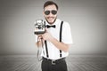 Composite image of geeky hipster holding a retro camera Royalty Free Stock Photo