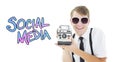 Composite image of geeky hipster holding a retro camera Royalty Free Stock Photo