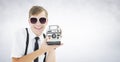 Composite image of geeky hipster holding a retro camera Royalty Free Stock Photo