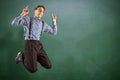 Composite image of geeky hipster jumping and pointing